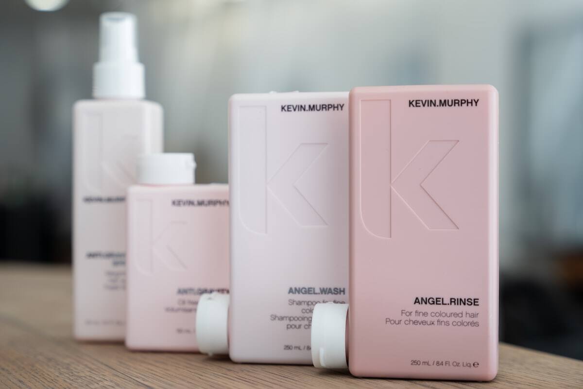 Row of professional hair care packaging on a light background