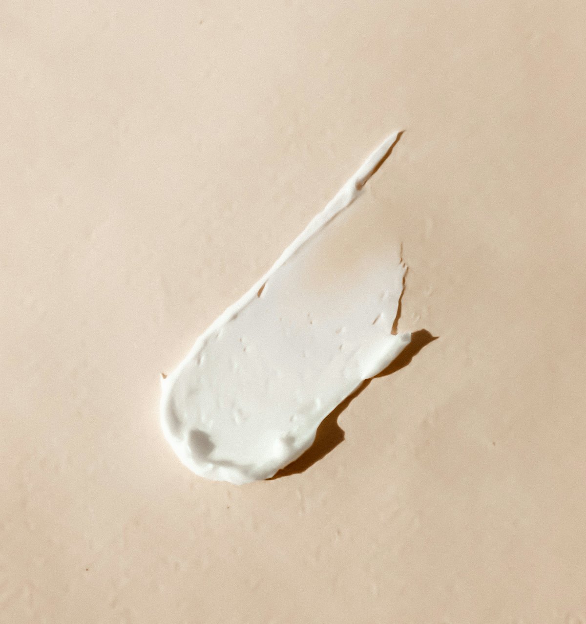 Smear of white cream on a neutral surface