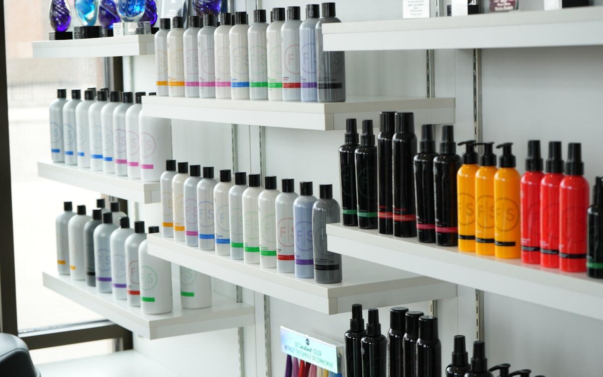Retail shelves stocked with hair care bottles