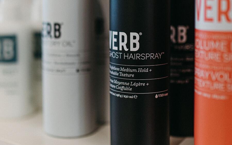 Hairspray and finishing product bottles lined up on a shelf