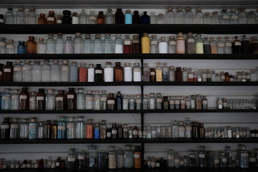 Stocked pharmacy shelving seen down an aisle
